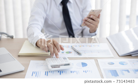 Accounting businessmen are calculating income-expenditure and analyzing real estate investment data, Dedicated to the progress and growth of the company, Financial and tax systems concept. Accounting businessmen are calculating income-expenditure and analyzing real estate investment data, Dedicated to the progress and growth of the company, Financial and tax systems concept. 73143483