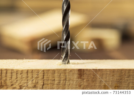 Closeup of wood drill bit with sawdust Closeup of wood drill bit with sawdust 73144353