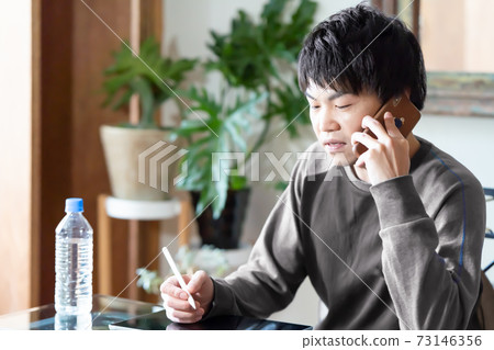 A man talking on a smartphone in the morning A man talking on a smartphone in the morning 73146356
