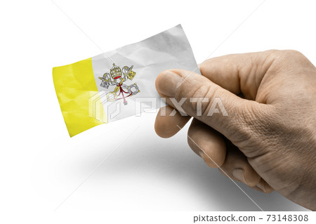 Hand holding a card with a national flag the Vatican 73148308