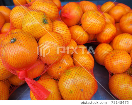 Mandarin oranges on the net are on sale 73148475