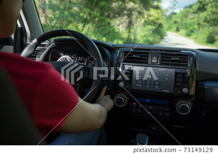 Driving off road car in the nature,hand start the engine 73149129