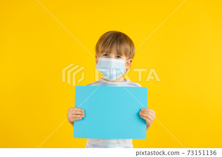 Portrait of kid wearing protective mask against yellow background 73151136