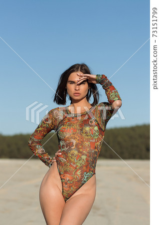 Sensual young lady on beach 73151799