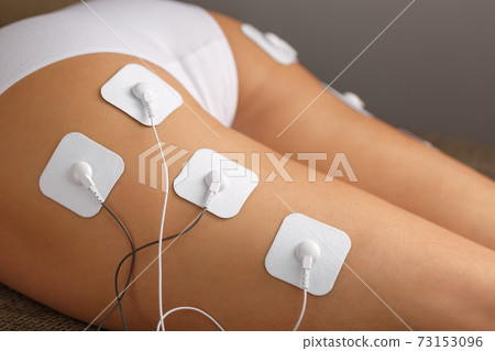 Massage the buttocks and legs with a myostimulator with attached electrodes. 73153096