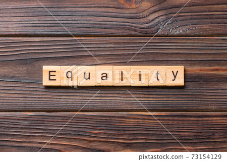 Equality word written on wood block. Equality text on cement table for your desing, concept Equality word written on wood block. Equality text on cement table for your desing, concept 73154129