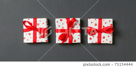 Holiday composition of gift boxes with red hearts on colorful background with empty space for your design. Top view of Valentine's Day concept 73154444