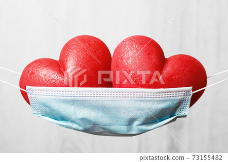 Two red hearts in a face mask hammock Two red hearts in a face mask hammock 73155482
