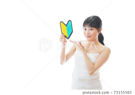 A young woman with a camisole with a beginner mark 73155565