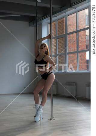 Slim woman dancing on pole 73155792