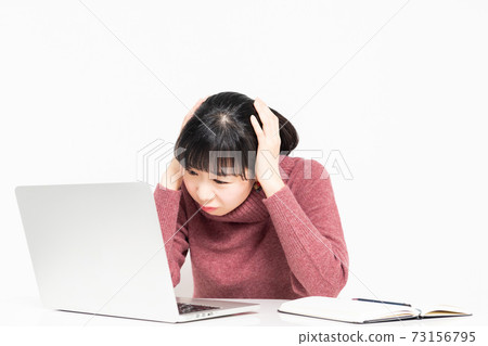A woman in trouble while using a computer A woman in trouble while using a computer 73156795