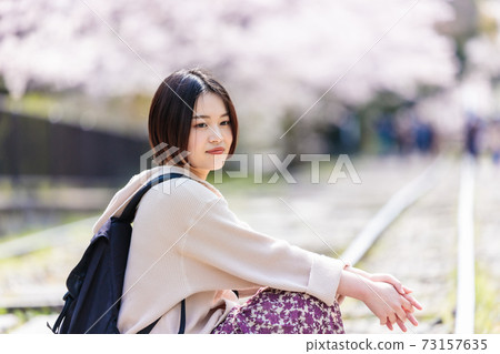 A woman watching cherry blossoms at Keage Incline during sightseeing in Kyoto A woman watching cherry blossoms at Keage Incline during sightseeing in Kyoto 73157635