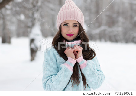 Stylish young lady in winter countryside 73159061