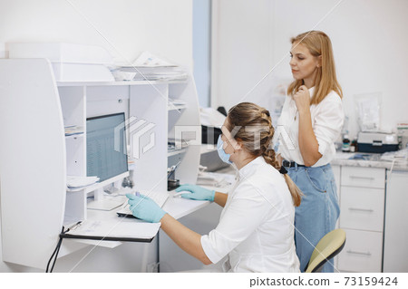 Doctor checks coronavirus test with patient Doctor checks coronavirus test with patient 73159424
