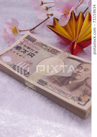 An image of a spring celebration or anniversary with origami celebration cranes and artificial flower cherry blossoms attached to the money wrapped in a traditional Japanese pattern strap 73159634