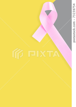 Pink ribbon on gray yellow background. Cancer concept 73159754