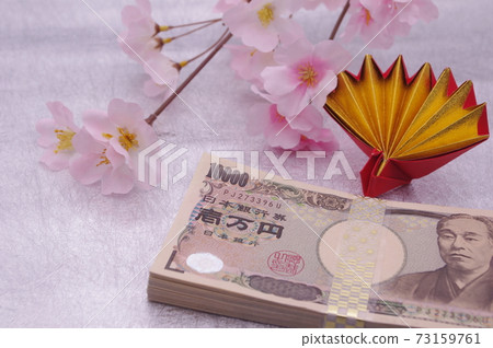 An image of a spring celebration or anniversary with origami celebration cranes and artificial flower cherry blossoms attached to the money wrapped in a traditional Japanese pattern strap 73159761