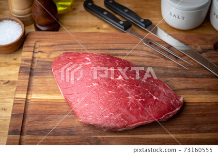 raw flank steak on wooden cutting board raw flank steak on wooden cutting board 73160555