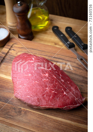 raw flank steak on wooden cutting board 73160556