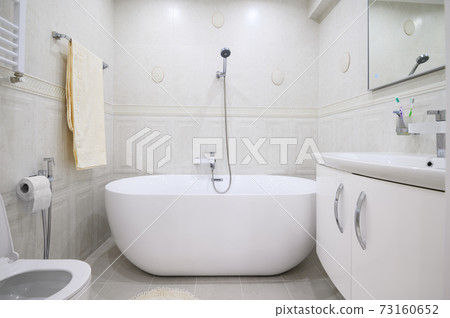Compact white cozy bathroom with bathub Compact white cozy bathroom with bathub 73160652