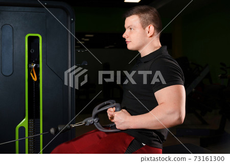 The guy performs a deadlift exercise while sitting on a bench. 73161300