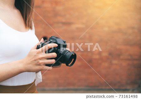 Asian woman traveling and photographing the city wall tha pae gate landmark of Chiang Mai Thailand Asian woman traveling and photographing the city wall tha pae gate landmark of Chiang Mai Thailand 73161498