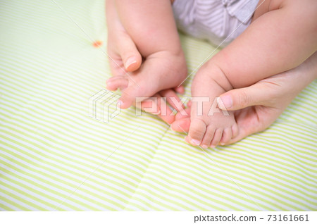 Baby feet in mother hand concept of love and Happiness of maternity Baby feet in mother hand concept of love and Happiness of maternity 73161661