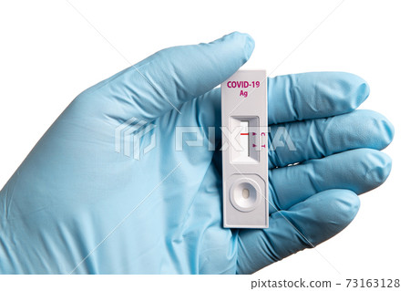 COVID-19 rapid test cassette with the negative result in the doctor's hand isolated on white macro 73163128