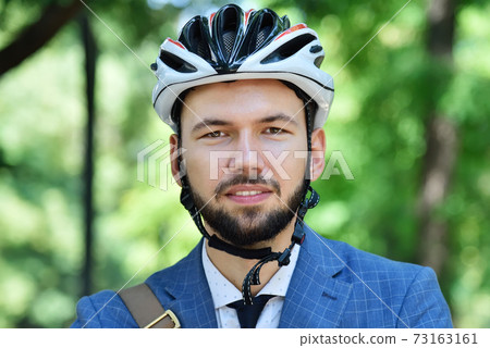 Young bearded businessman in helmet 73163161
