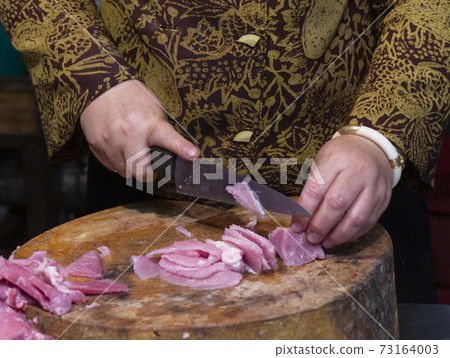 Closeup of Hands of Woman Slicing Meat Closeup of Hands of Woman Slicing Meat 73164003