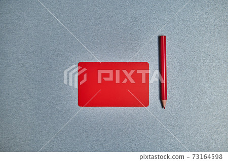 Flat lay with red card and red pencil on a gray background. Copy space Flat lay with red card and red pencil on a gray background. Copy space 73164598
