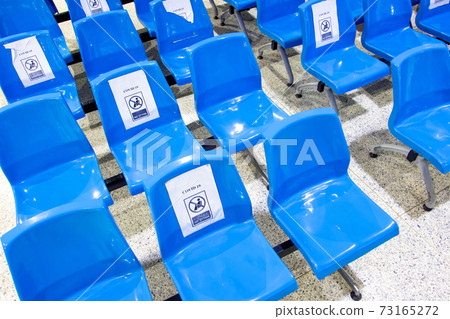 A empty seats at public area with a warning to keep the social distance A empty seats at public area with a warning to keep the social distance 73165272