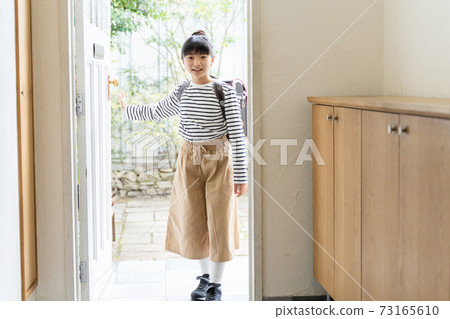 Elementary school girl standing at the entrance 73165610