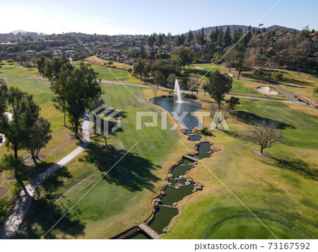 Aerial view of golf in green valley Aerial view of golf in green valley 73167592