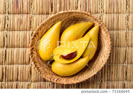 Eggfruit or canistel in a basket, Thai fruit 73168045