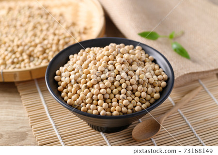 Soybeans seed in a black bowl with spoon  73168149