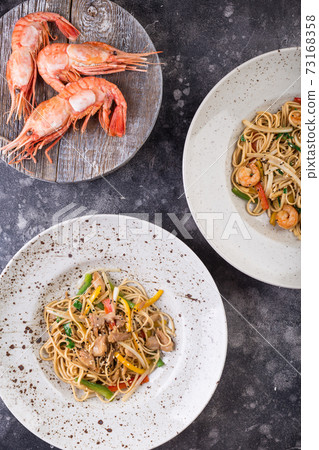 Several dishes. Healthy whole-grain spaghetti with shrimp, chicken and vegetables, pasta. Top View. Several dishes. Healthy whole-grain spaghetti with shrimp, chicken and vegetables, pasta. Top View. 73168358
