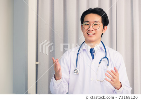 Doctor man smiling talking online video conference Doctor man smiling talking online video conference 73169120