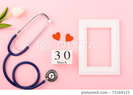 Doctor's Day concept, flat lay top view, equipment medical red heart stethoscope and photo frame Doctor's Day concept, flat lay top view, equipment medical red heart stethoscope and photo frame 73169125
