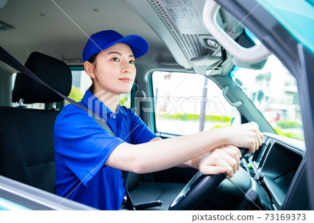 Female driver driving Female driver driving 73169373