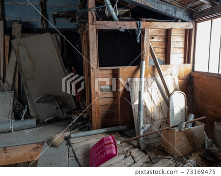 Inside the old warehouse shed of a farmhouse 73169475