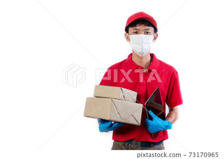 Delivery man in medical safety mask holding and carrying a card and tablet isolated on white background Delivery man in medical safety mask holding and carrying a card and tablet isolated on white background 73170965
