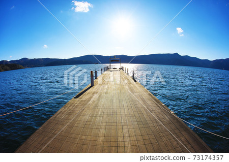 Pier to the shining lake surface 73174357