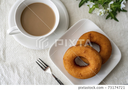 Donuts and milk tea on a white plate 73174721