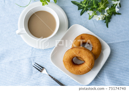 Donuts and milk tea on a white plate Donuts and milk tea on a white plate 73174740