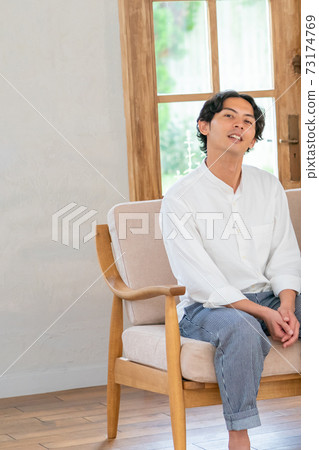 Men sitting on the sofa Men sitting on the sofa 73174769