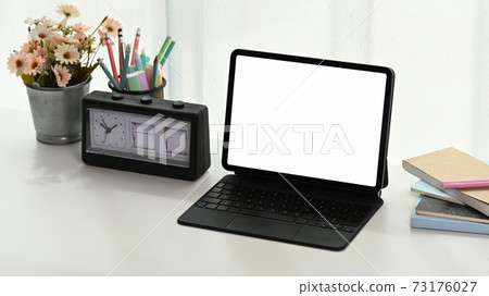 Comfortable workspace with mock up empty screen computer tablet and accessories on white table. 73176027