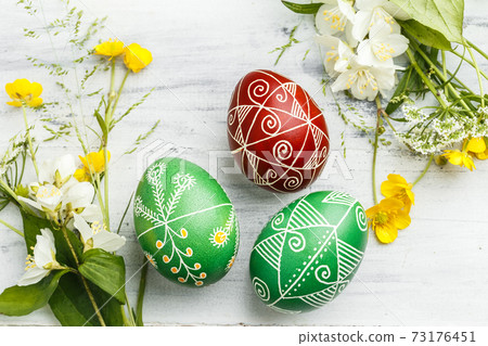 Red and green Easter pysanka eggs with flowers Red and green Easter pysanka eggs with flowers 73176451