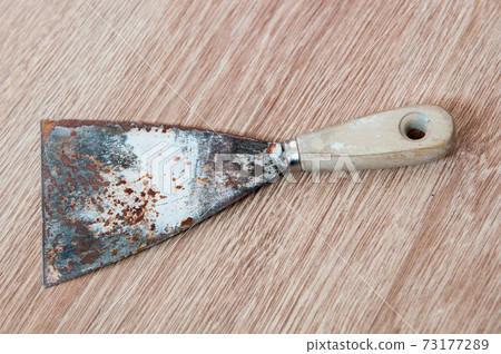 Putty kniFe with wooden handle over isolated white background 73177289