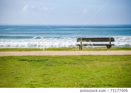 Wood bench near beach and sea Wood bench near beach and sea 73177806